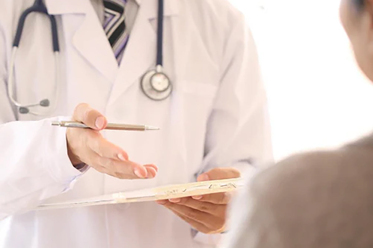 Doctor with a clipboard explaining